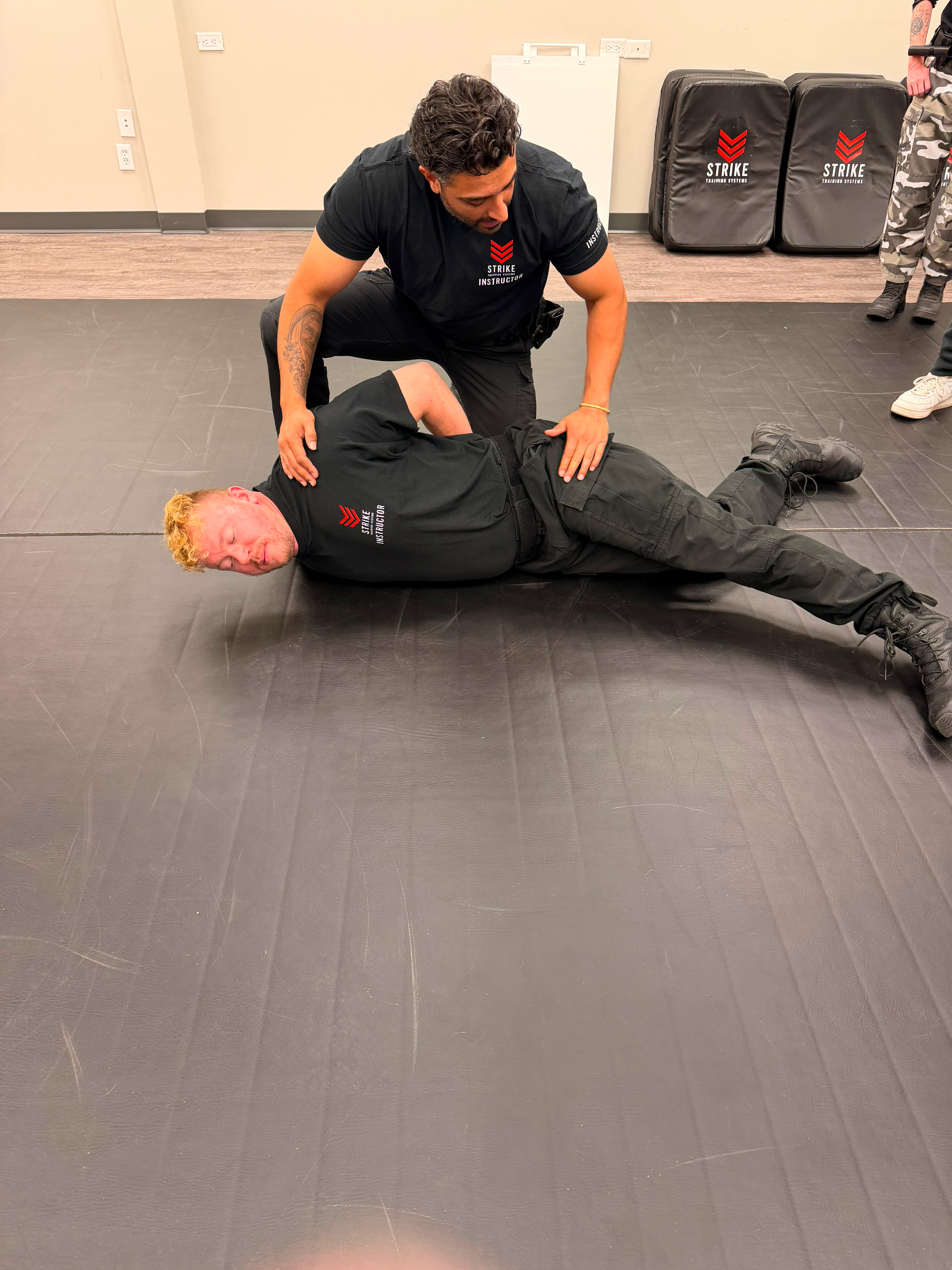 strike-training-systems-calgary-instructor-ground-control-prone-restraint-01-Calgary