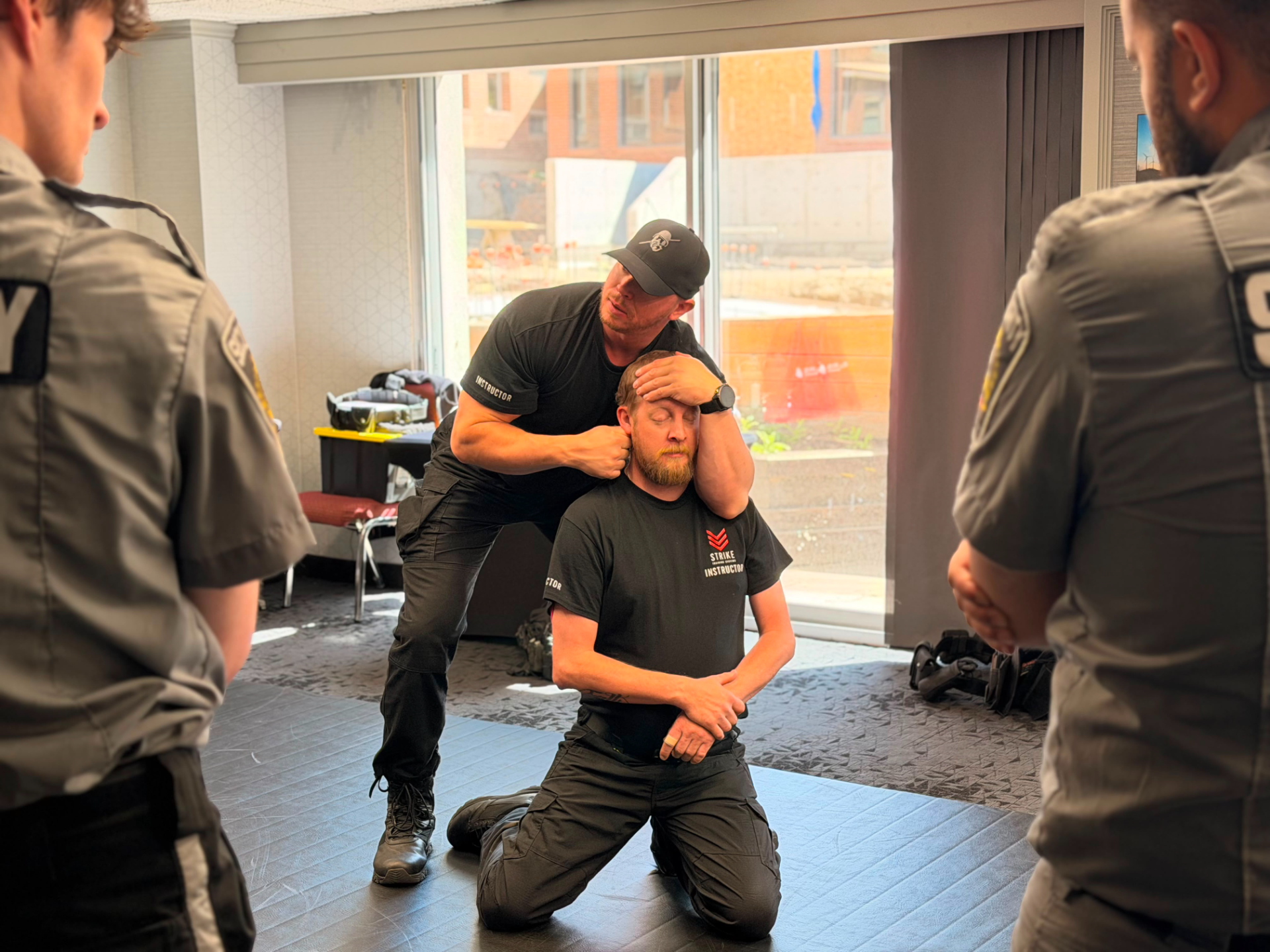 strike-training-systems-calgary-instructor-head-control-restraint-demo-01-Calgary