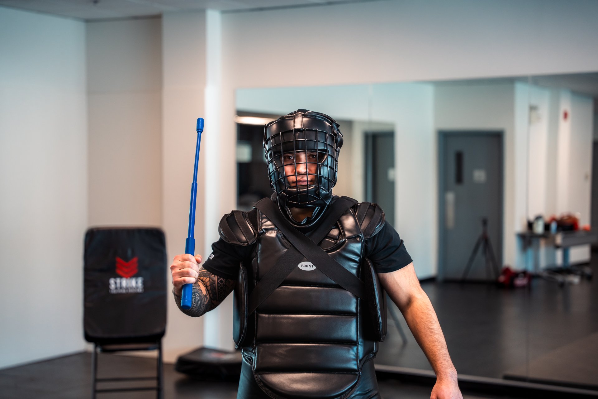 strike-training-systems-calgary-instructor-redman-suit-baton-training-01-Calgary
