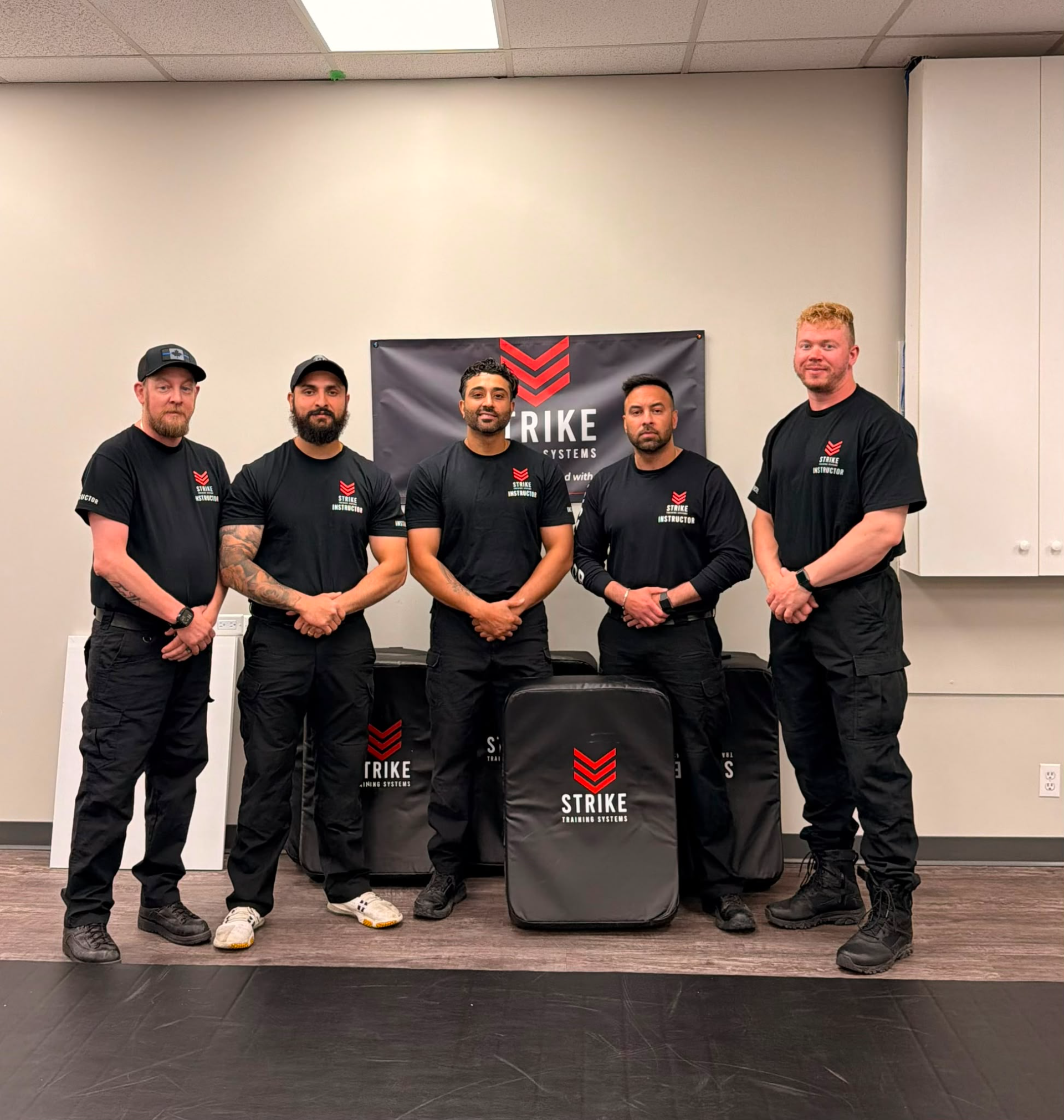 strike-training-systems-calgary-instructor-team-photo-shield-pads-01-Calgary