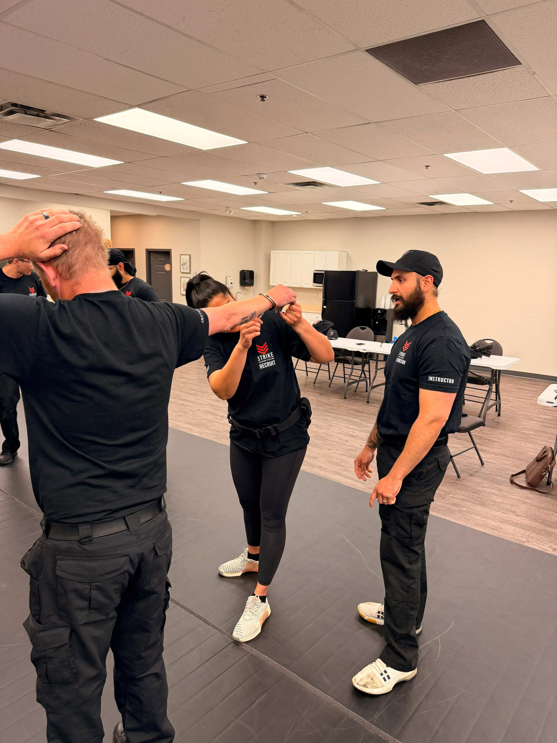 strike-training-systems-calgary-instructor-wrist-control-escort-technique-01-Calgary